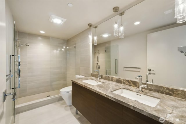 588 Bell St Unit 1603S, Seattle, WA 98121 - bathroom with toilet, a shower stall, double vanity, and recessed lighting