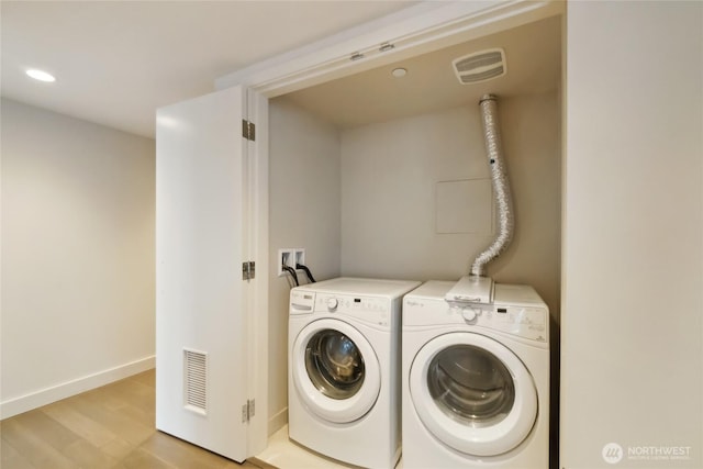 588 Bell St Unit 1603S, Seattle, WA 98121 - washroom featuring washing machine and dryer, light wood-style flooring, baseboards, and recessed lighting