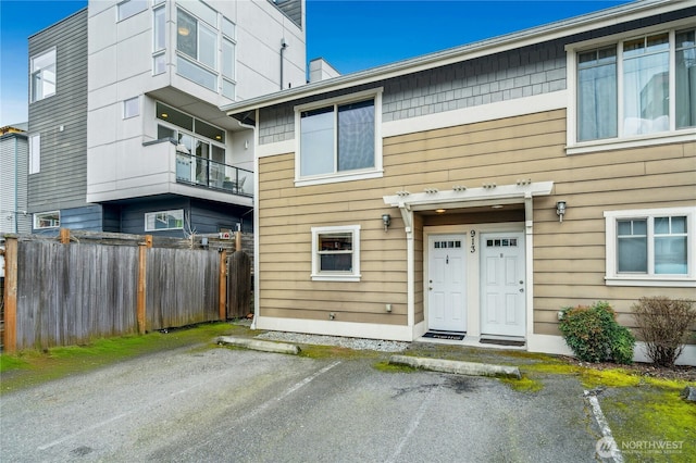 exterior space featuring uncovered parking and fence