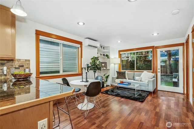 living area featuring recessed lighting, a wall unit AC, and wood finished floors