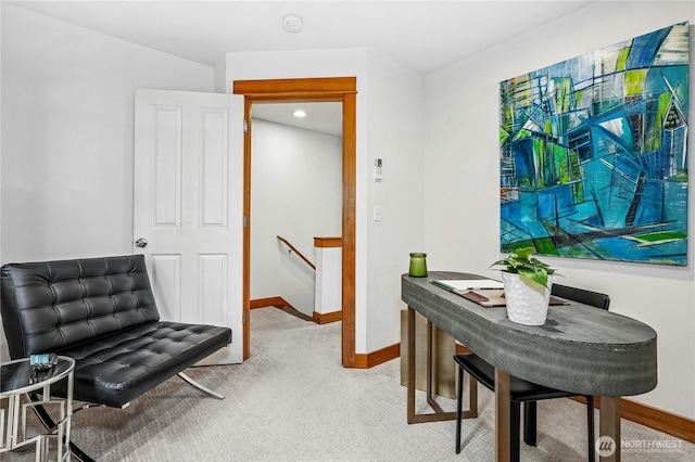 living area with an upstairs landing, baseboards, and light carpet