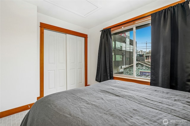 bedroom with baseboards and a closet