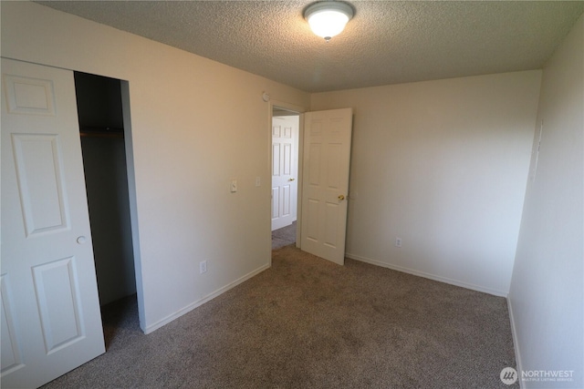 unfurnished bedroom with a closet, baseboards, carpet, and a textured ceiling