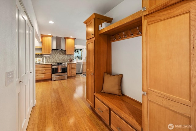 mudroom with light wood finished floors and recessed lighting