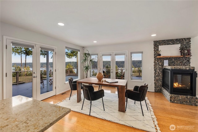 dining area featuring wood finished floors, french doors, visible vents, and a healthy amount of sunlight