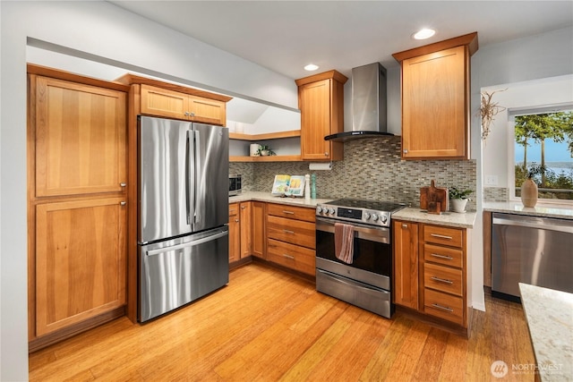 kitchen featuring open shelves, stainless steel appliances, light wood-style floors, wall chimney exhaust hood, and tasteful backsplash