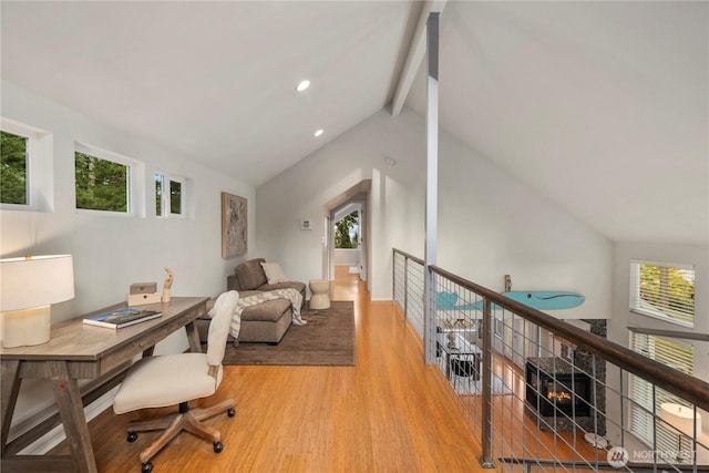 office area featuring recessed lighting, a healthy amount of sunlight, vaulted ceiling with beams, and wood finished floors