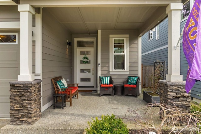 doorway to property featuring a garage and covered porch