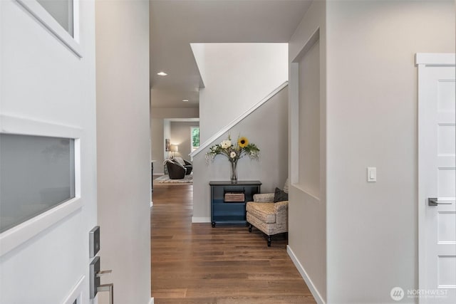 hallway with baseboards and wood finished floors