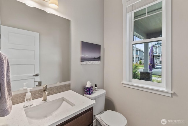 half bath featuring toilet and vanity