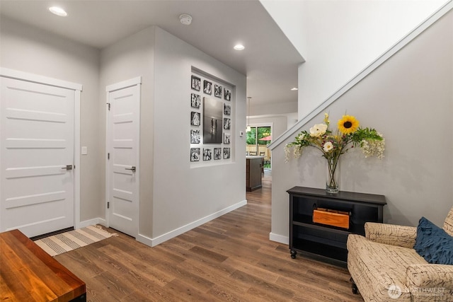 corridor with stairway, recessed lighting, baseboards, and wood finished floors