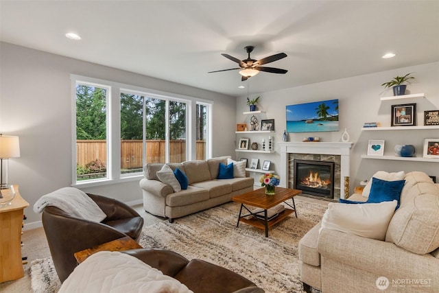 living area featuring a tiled fireplace, recessed lighting, carpet floors, baseboards, and ceiling fan