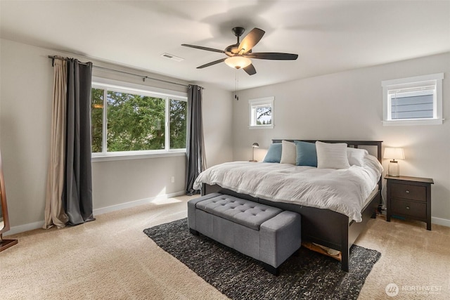 carpeted bedroom with visible vents, ceiling fan, and baseboards