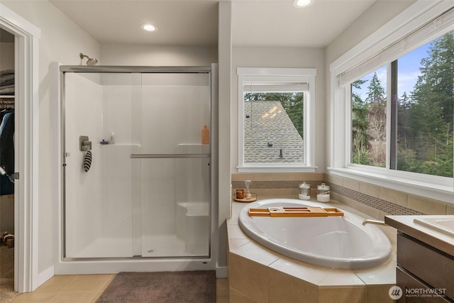 bathroom featuring vanity, recessed lighting, a stall shower, tile patterned flooring, and a garden tub