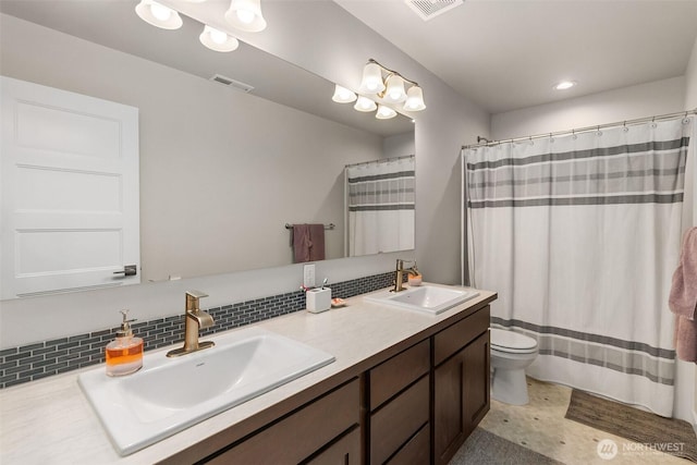 full bath with tasteful backsplash, visible vents, toilet, and a sink