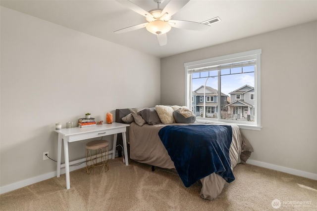 bedroom with visible vents, baseboards, carpet, and ceiling fan