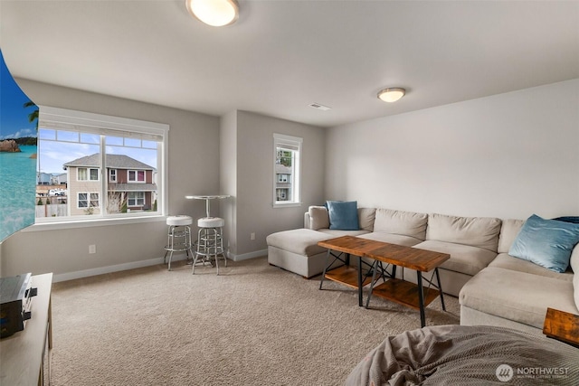 carpeted living room featuring baseboards