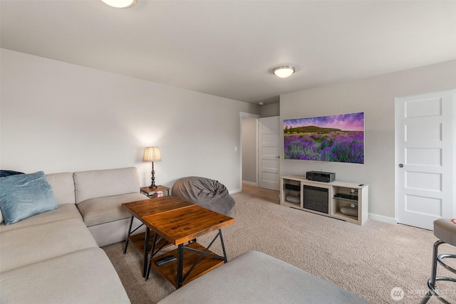 carpeted living area featuring baseboards