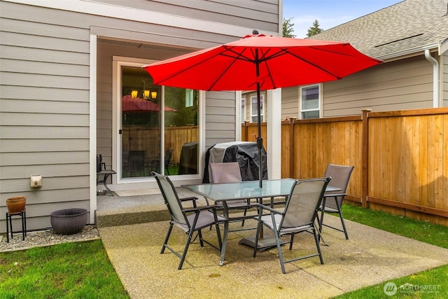 view of patio / terrace featuring outdoor dining area, grilling area, and fence