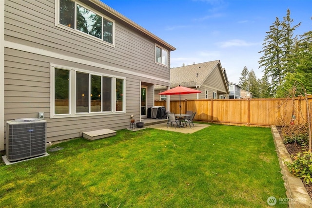 back of house featuring a lawn, a patio, central AC, and fence