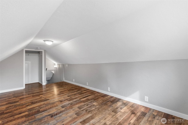 bonus room featuring vaulted ceiling, wood finished floors, and baseboards