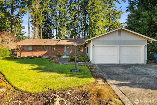 ranch-style house featuring a front lawn, an attached garage, and driveway