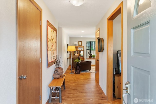 corridor with light wood-style floors