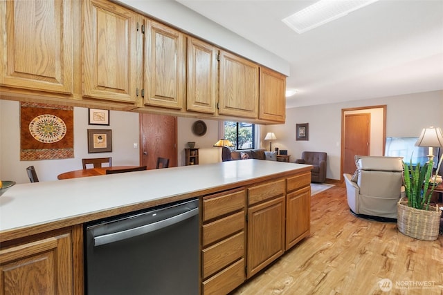 kitchen featuring dishwasher, light countertops, open floor plan, and light wood-type flooring