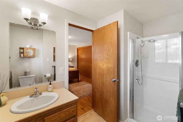 ensuite bathroom with vanity, ensuite bath, toilet, and a stall shower