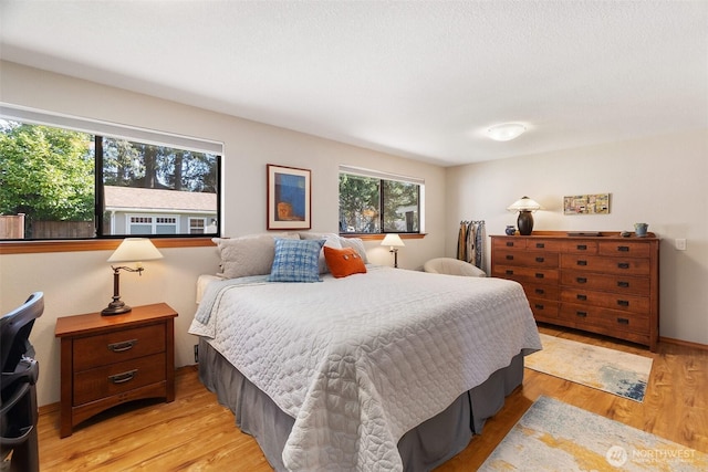 bedroom featuring baseboards and light wood-type flooring