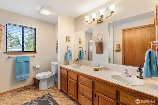 bathroom with double vanity, visible vents, toilet, and a sink