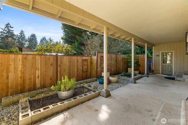 view of patio / terrace with a garden and a fenced backyard