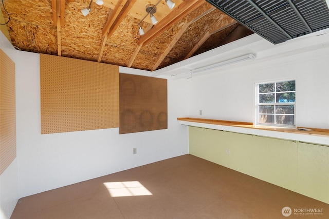 unfurnished room featuring vaulted ceiling