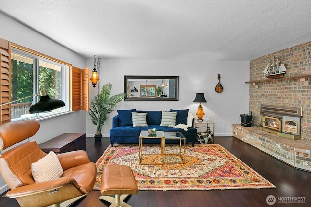 20417 Pugh Rd NE, Poulsbo, WA 98370 - living room featuring a textured ceiling, hardwood / wood-style floors, baseboards, and a fireplace