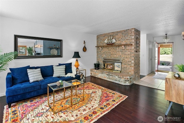 20417 Pugh Rd NE, Poulsbo, WA 98370 - living room featuring a textured ceiling, wood finished floors, and a brick fireplace