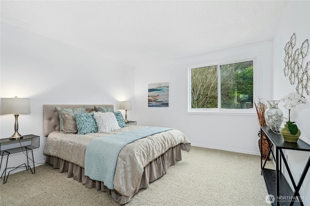 carpeted bedroom with baseboards