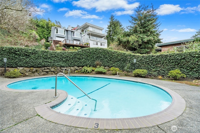 view of swimming pool featuring a fenced in pool and fence