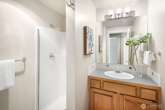 bathroom with vanity and a shower stall