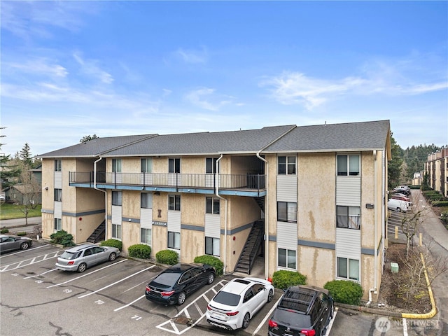 view of property featuring uncovered parking