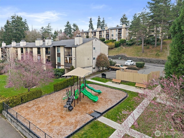 community jungle gym featuring a residential view and fence