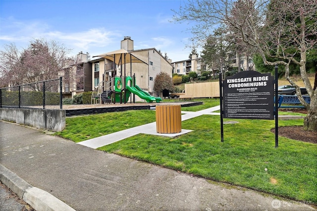 community playground with a yard and fence