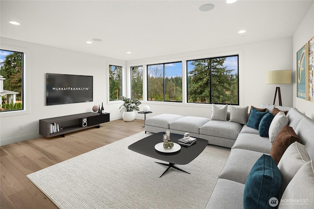 living room featuring plenty of natural light, wood finished floors, and recessed lighting