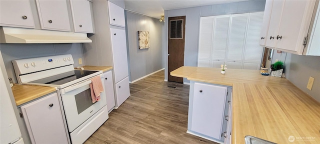 kitchen featuring under cabinet range hood, white electric stove, white cabinetry, and light wood-type flooring