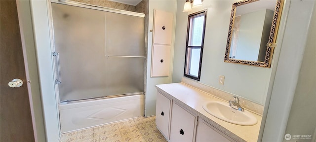 full bathroom with vanity and shower / bath combination with glass door