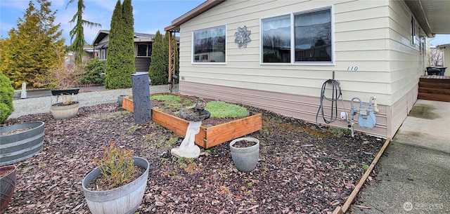 view of side of property with a garden