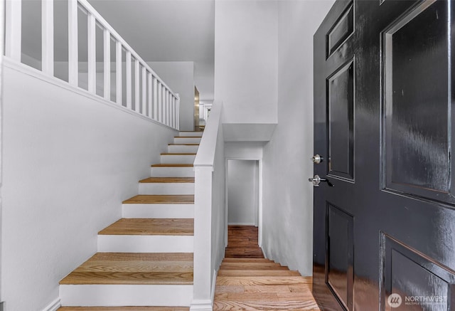 staircase with wood finished floors