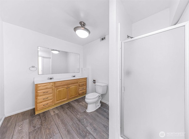 full bathroom featuring visible vents, a stall shower, and wood finished floors