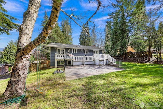 rear view of house featuring a yard, a patio, a deck, and fence