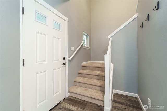 stairway featuring baseboards and wood finished floors