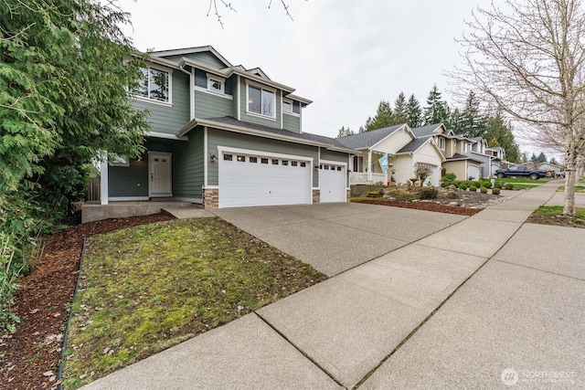 view of front of property featuring stone siding, concrete driveway, and an attached garage